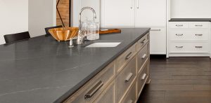 Kitchen Interior with Island, Sink, Cabinets, and Hardwood Floors in New Luxury Home